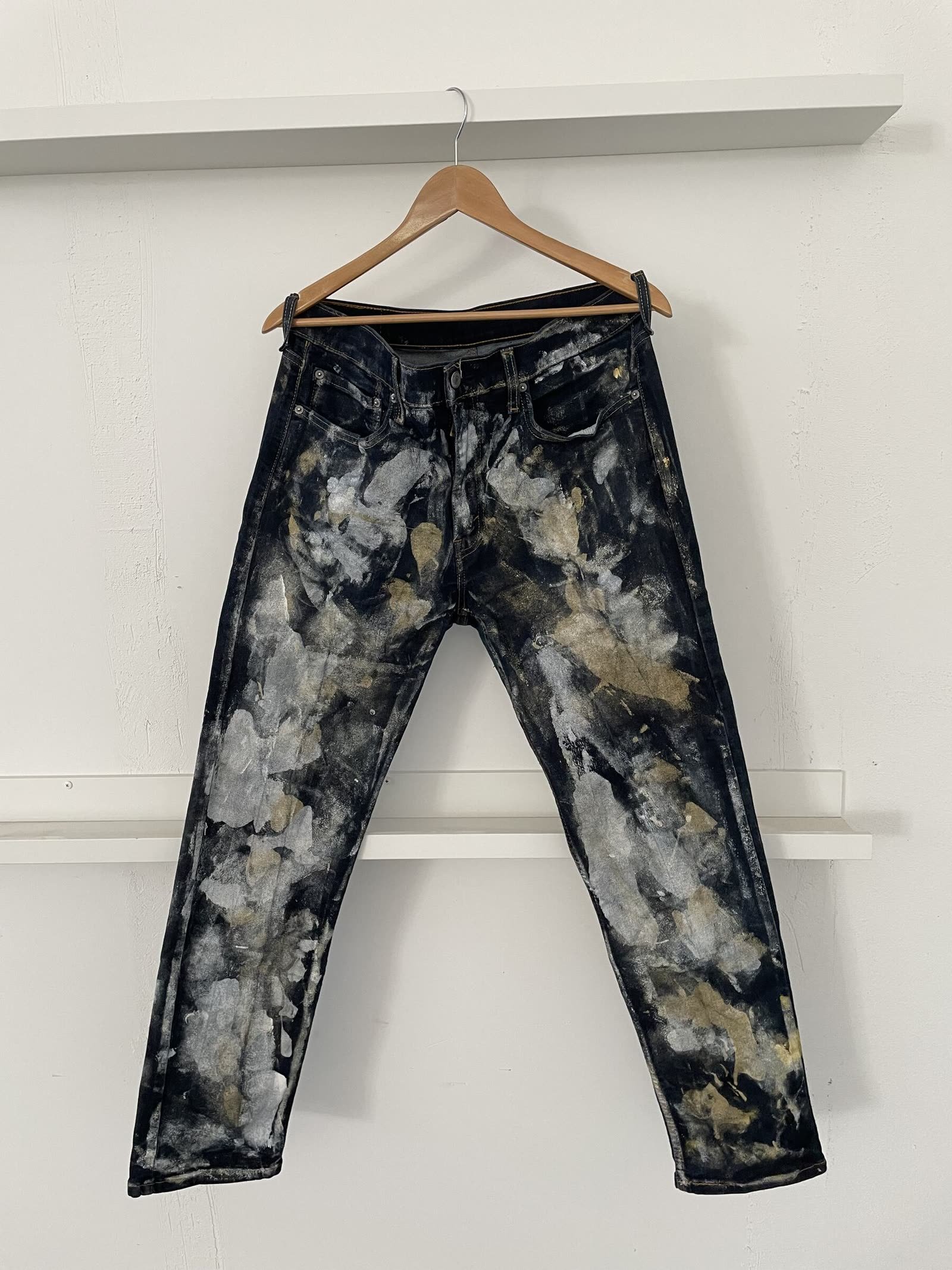 Customized dark denim jeans hand-bleached with silvery-grey and olive blotches.